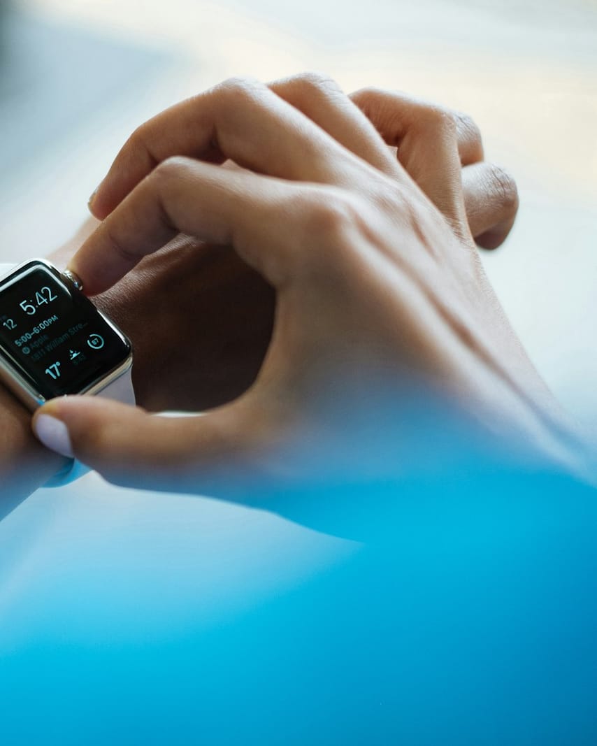 Person checking a smartwatch while walking